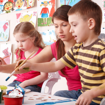 teacher teaching kids how to paint
